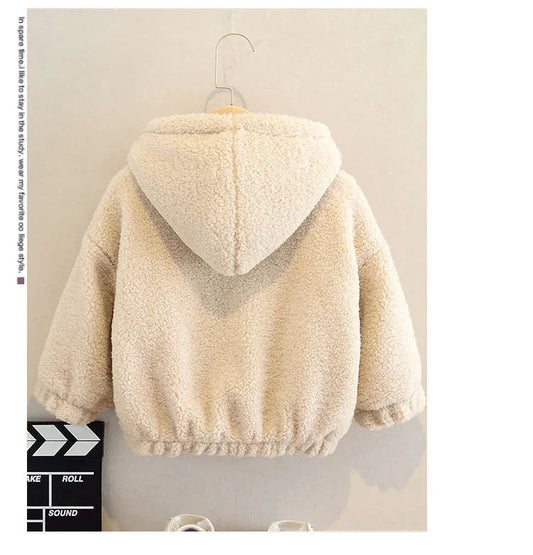 Beige sherpa fleece hooded jacket for kids hanging on wall hook