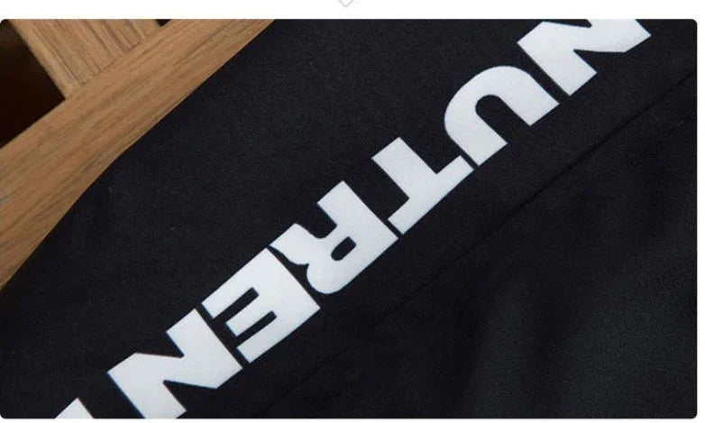 Black athletic fabric with bold white NUTREND text and wooden background