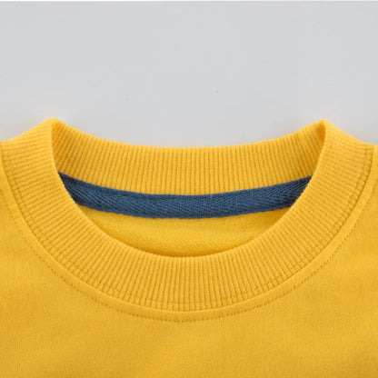 Close-up of yellow crew neck sweatshirt with ribbed collar and blue inner lining