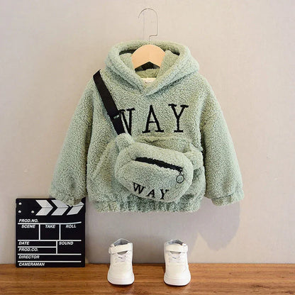 Kids sage green fleece hoodie with 'WAY' text, matching crossbody bag, white sneakers.