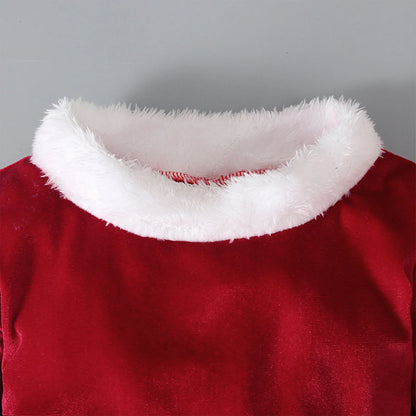 Red velvet top with white faux fur collar on gray background, festive clothing detail